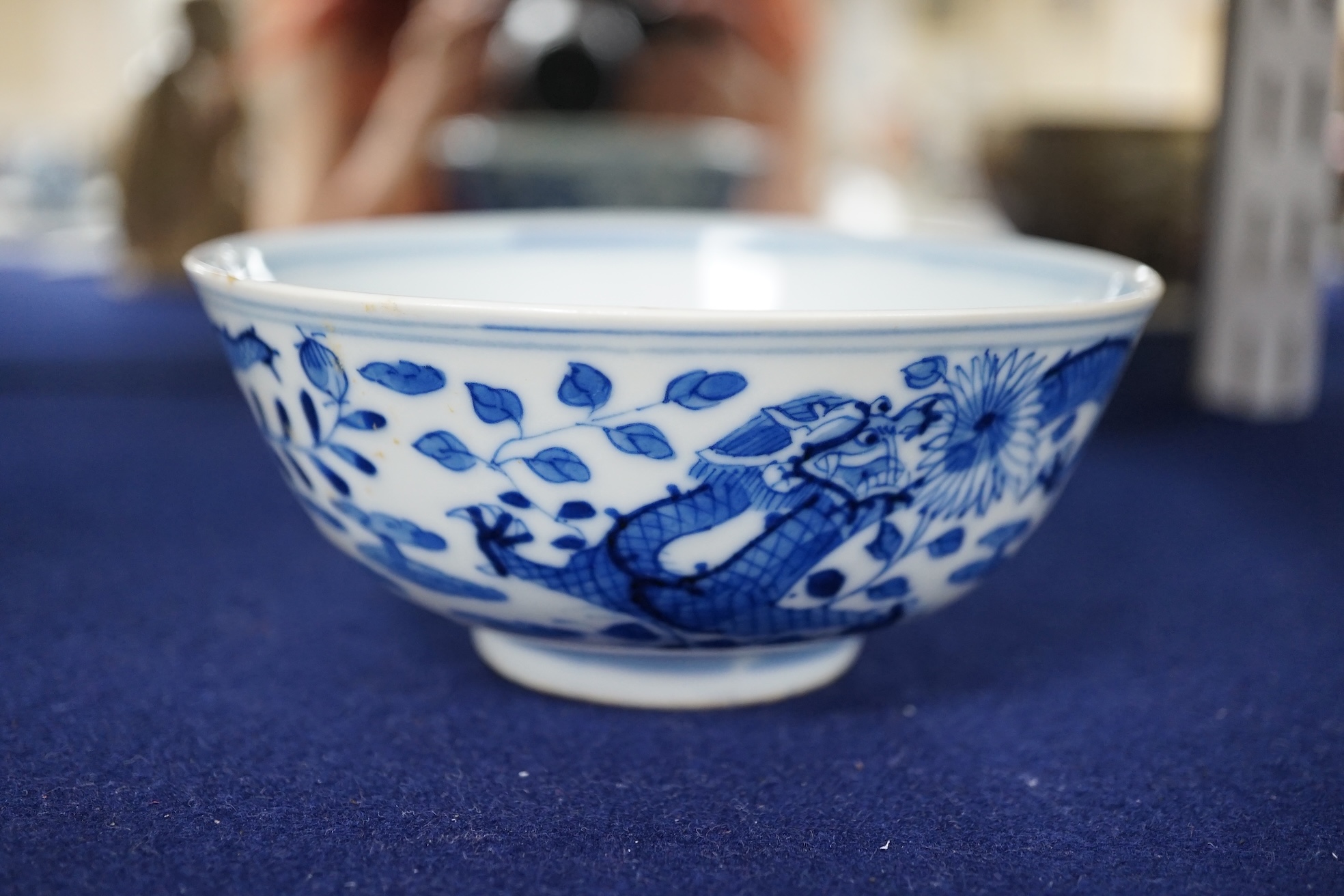 A Chinese blue and white ‘dragon’ bowl, Qianlong mark but 19th century, 12.5cm diameter. Condition - overglazed imperfection